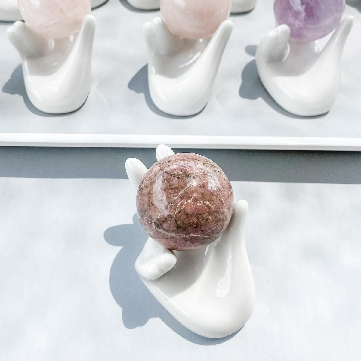 white ceramic hand shaped crystal sphere holder gemrox australia