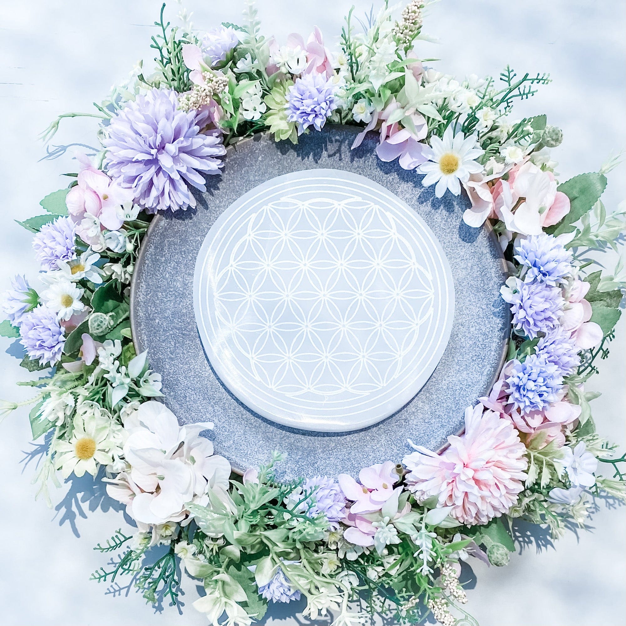 These beautiful Selenite Charging Plates with a flower of life pattern are perfect to use for charging your crystals. Placing your crystals on the charging plate will cleanse and recharge them of their existing energy. These can also be used for Crystal Grid Work.